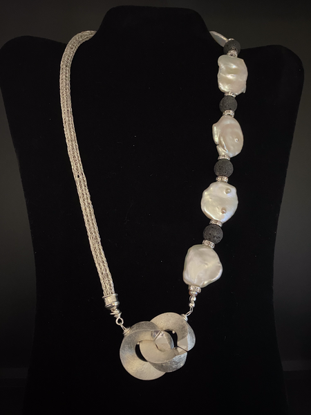 Asymmetrical flat pearl with lava bead